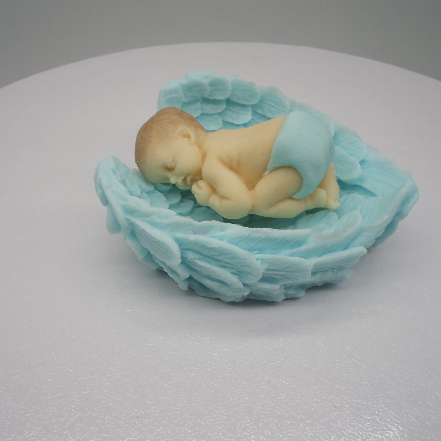 Tortendeko Baby in Flügeln blau