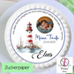White frosted baptism cake with edible topper of baby Elias, lighthouse illustration, and date 23.04.2023.